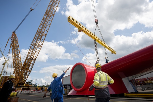 Crews used cranes to install the funnel in place atop Carnival Jubilee at Meyer Werft in Papenburg G